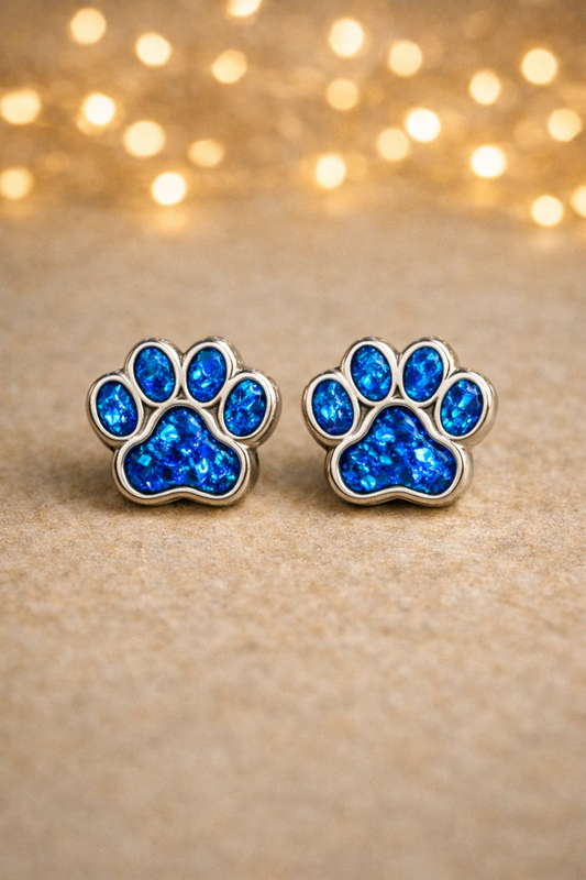 blue earring in pawprint shape, with ashes hair or fur, pet memorial