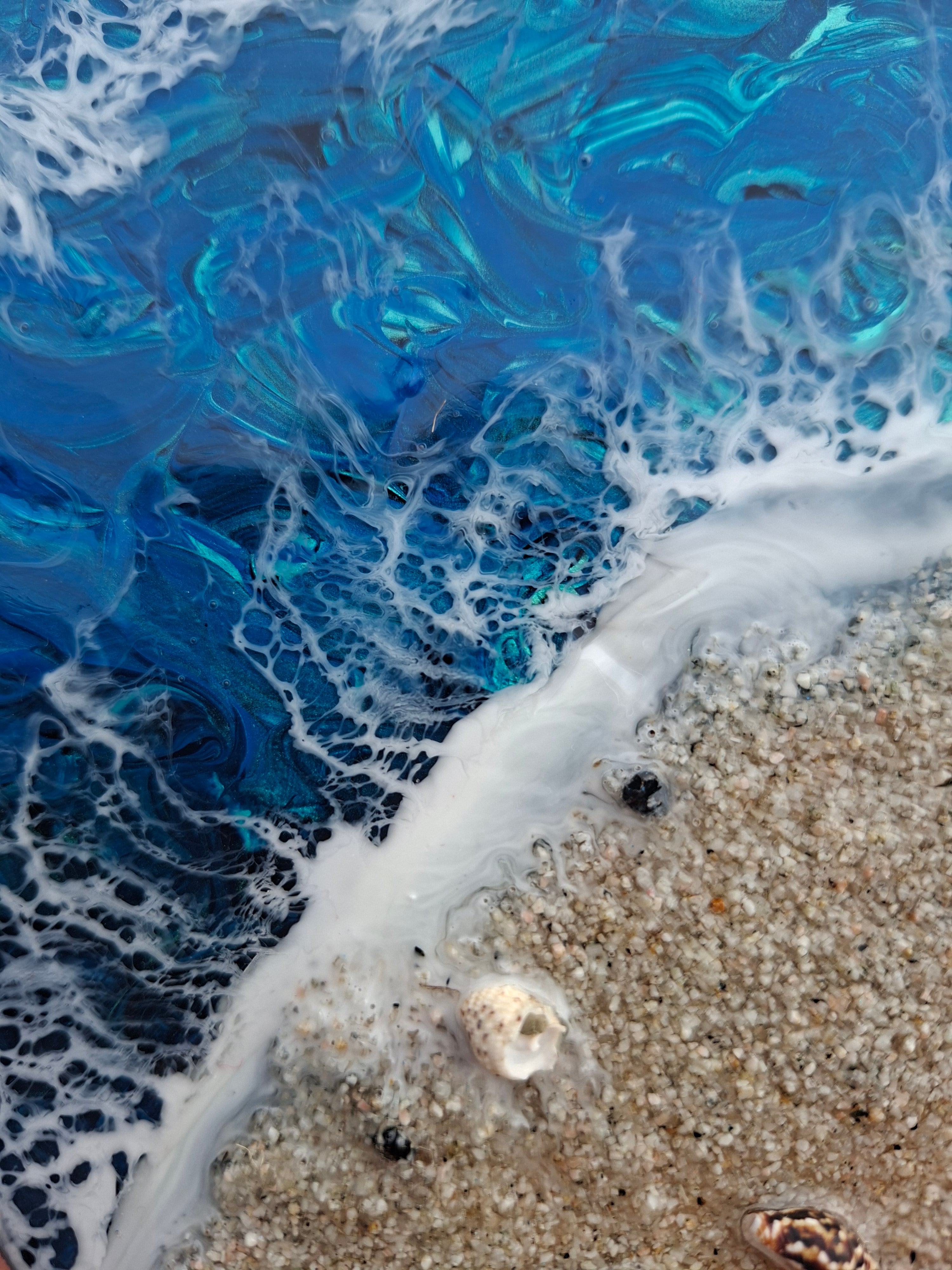 Load video: an ocean themed artwork containing cremation ashes in the sand is framed.