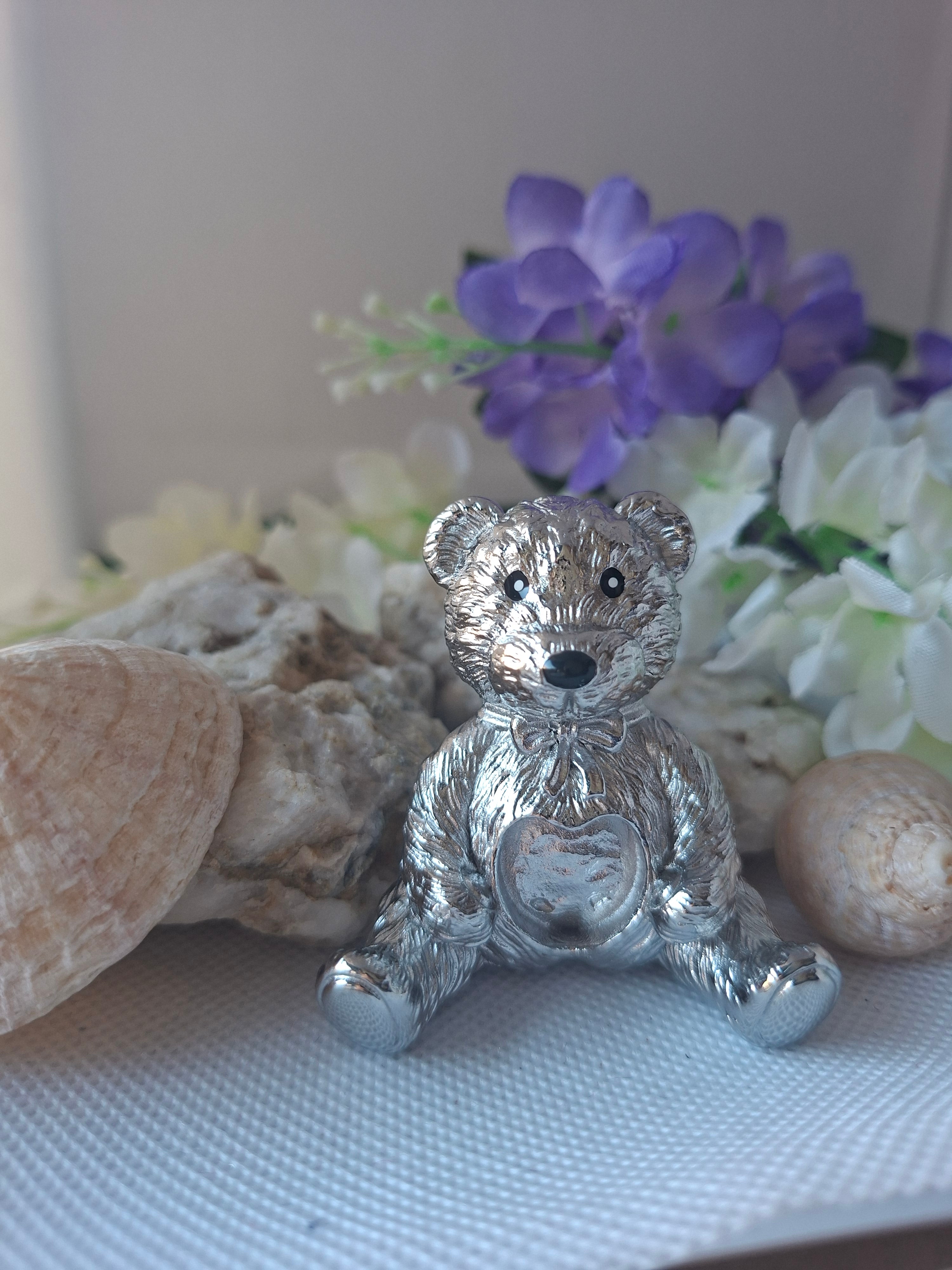 Load video: a process video showing a stainless steel memorial bear ornament being filled with cremation ashes and crushed opals to create a keepsake to treasure